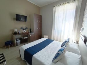 Postel nebo postele na pokoji v ubytování Domos La Corte Ghibellina