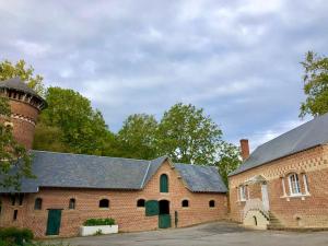 an old brick building with a silo on top of it at Maison de charme Suzanne in Suzanne