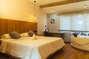 a bedroom with a large bed in a room at Casa Origo Hospedaje in Medellín