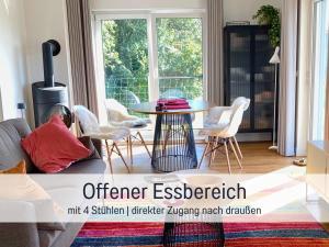 a living room with a table and chairs at Ferienhaus Kalea in Userin