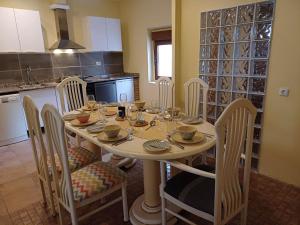 a kitchen with a table with chairs and a dining room at Kitsch apartment in Rasquera