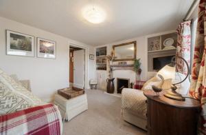 a living room with a bed and a fireplace at Cottage On The Common in Great Malvern