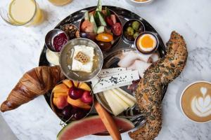 a black plate of food with different types of food at Hotel Brummell in Barcelona
