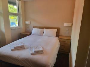 a bedroom with a white bed with two pillows on it at Coventry Hill Hotel in Coventry