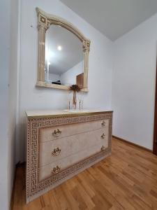 a dresser with a mirror on top of it at Meduza Wellness Spa s ubytovaním in Hlohovec +27 photos