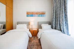 Postel nebo postele na pokoji v ubytování Al Bustan Centre & Residence