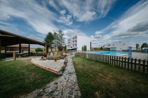a resort with a swimming pool and a fence at Air ROOMS in Holiša
