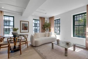 a living room with a white couch and a table at The Mercer Boutique Hotel in Montreal