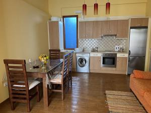 a kitchen with a table and a dining room at CHC - Apartamento Amanecer in Buenavista del Norte