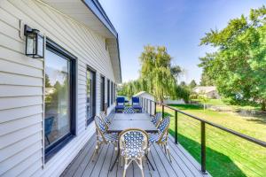 a deck with a table and chairs on a house at Kalispell Gem Deck, Yard and Fireplace in Kalispell