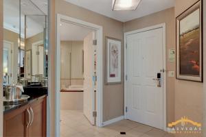 a kitchen with a door leading to a bathroom at MGM Signature-03-703 Strip View Jacuzzi Studio in Las Vegas
