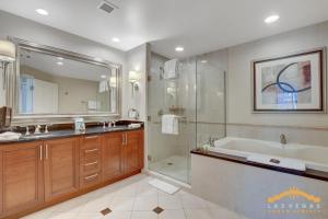 a bathroom with a tub and a shower and a sink at MGM Signature-03-703 Strip View Jacuzzi Studio in Las Vegas +41 photos