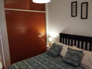 a bedroom with a bed with two pillows at DORREGO 17 BIS in Rosario