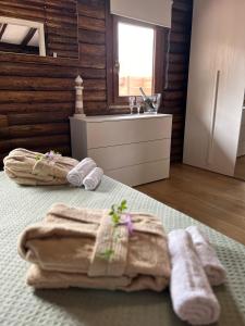 a bathroom with two towels on a bed at Chalet Seaview by AR Group Hotels in Isola delle Femmine