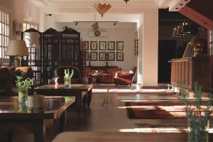 a living room with tables and chairs and a couch at Domaine de la Roseraie Resort in Ouirgane