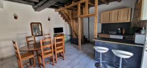 a kitchen with a table and chairs in a room at Chambres d'Hôtes Chez Jean in Spoy