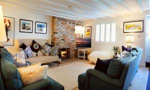 a living room with two couches and a fireplace at Flora Dora - Luxury cottage - modern - central - ideal for groups and families in Filey