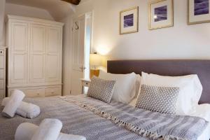 a bedroom with a large bed with two pillows at Flora Dora - Luxury cottage - modern - central - ideal for groups and families in Filey