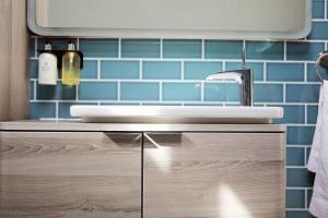 a bathroom with a sink and blue tiles at Flora Dora - Luxury cottage - modern - central - ideal for groups and families in Filey