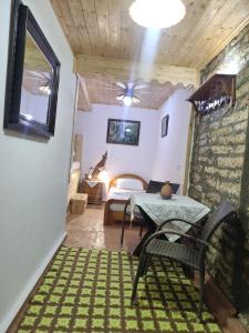 a room with a table and a bed and a bedroom at Karafil Guesthouse in Gjirokastër