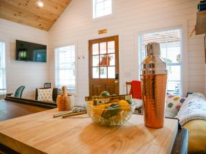 a bottle on a table with a bowl of fruit at Lincolville's First Schoolhouse! in St. Augustine