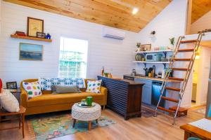 a living room with a couch and a kitchen at Lincolville's First Schoolhouse! in St. Augustine