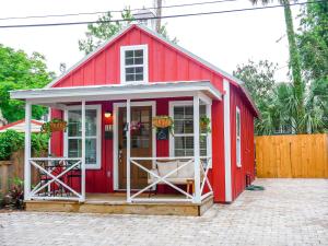 a red shed with a white door and windows at Lincolville's First Schoolhouse! in St. Augustine