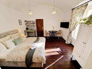 a bedroom with a bed and a dining room at Helena Old Town Apartment in Košice