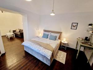 a bedroom with a bed and a living room at Helena Old Town Apartment in Košice