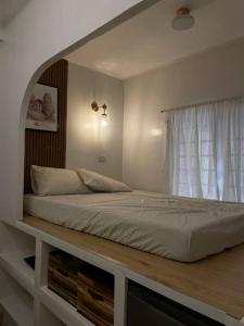 a large bed in a bedroom with a window at Modern Home in Pampanga Near Clark with Parking in Pulungmaragul