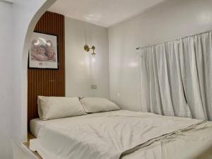 a bedroom with a white bed with a window at Modern Home in Pampanga Near Clark with Parking in Pulungmaragul +19 photos