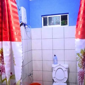 a bathroom with a toilet with a window at Kiansom Homestay - Waterfall etc in Kota Kinabalu