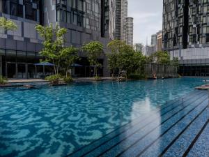 a swimming pool in a city with tall buildings at Star KLCC Elegant 2-3pax by DingDing in Kuala Lumpur