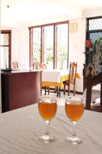 two glasses of wine sitting on a table at Panorama Accommodations Nuwara Eliya in Nuwara Eliya