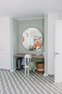 a room with a mirror and a desk with a table at Sierra del Mar in Playa del Ingles