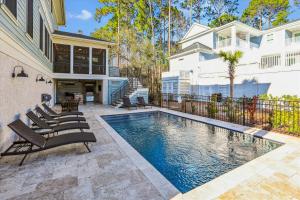 a swimming pool in the backyard of a house at 3 Shore Crest Lane- Chefs Kitchen, Game Room, Near Beach, Private Pool, FREE Activities Included in Hilton Head Island