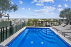 a swimming pool on a balcony with a view of the beach at 3 Singleton Beach - Oceanfront Estate, Private Pool, Elevator, FREE Activities Included in Hilton Head Island