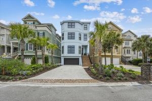 a large white house with palm trees in front of it at 3 Singleton Beach - Oceanfront Estate, Private Pool, Elevator, FREE Activities Included in Hilton Head Island
