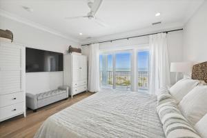 a bedroom with a large bed and a large window at 3 Singleton Beach - Oceanfront Estate, Private Pool, Elevator, FREE Activities Included in Hilton Head Island +40 photos