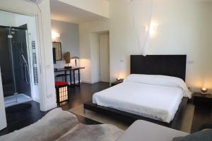 a bedroom with a large white bed and a window at Villa Lux Cinque Terre in La Spezia +35 photos
