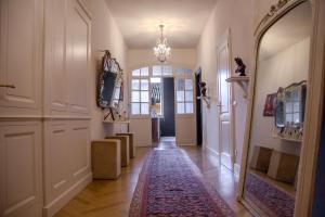 a hallway with a door and a rug on the floor at La Maison du Théâtre in Ravenna