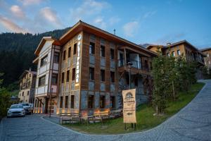 a large building with a sign in front of it at Ayder Altıparmak Suit in Ayder Yaylasi