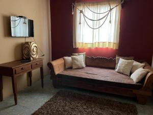 a living room with a couch and a window at Hotel Rinconada in San Miguel de Allende