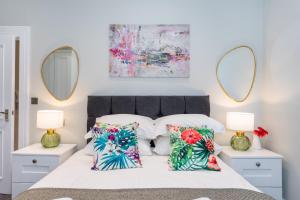 a bedroom with a bed with two mirrors at 5 Star - The Ulsterville Residences - Free On-site Parking in Belfast