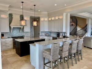 a kitchen with a large island with bar stools at 31 Singleton Beach- Oceanfront luxury home, spectacular views & private pool, FREE Activities Included in Hilton Head Island