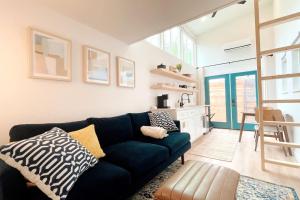 a living room with a couch and a table at Cozy and Bright Mid-Century Gem in Eastside Action in Austin