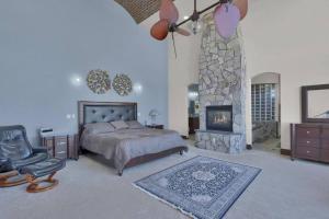 a bedroom with a bed and a fireplace at Luxury Mansion Retreat Sleeps 20 Panoramic VIEWS in Castle Rock