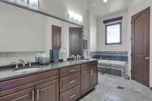 a bathroom with two sinks and a bath tub at Luxury Mansion Retreat Sleeps 20 Panoramic VIEWS in Castle Rock +47 photos