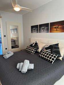 a bedroom with a large bed with black and white pillows at Atico Centro Sol y Vistas in Zaragoza
