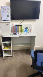 a white desk with a computer monitor on top of it at Ambassador INN in At-Tafilah
